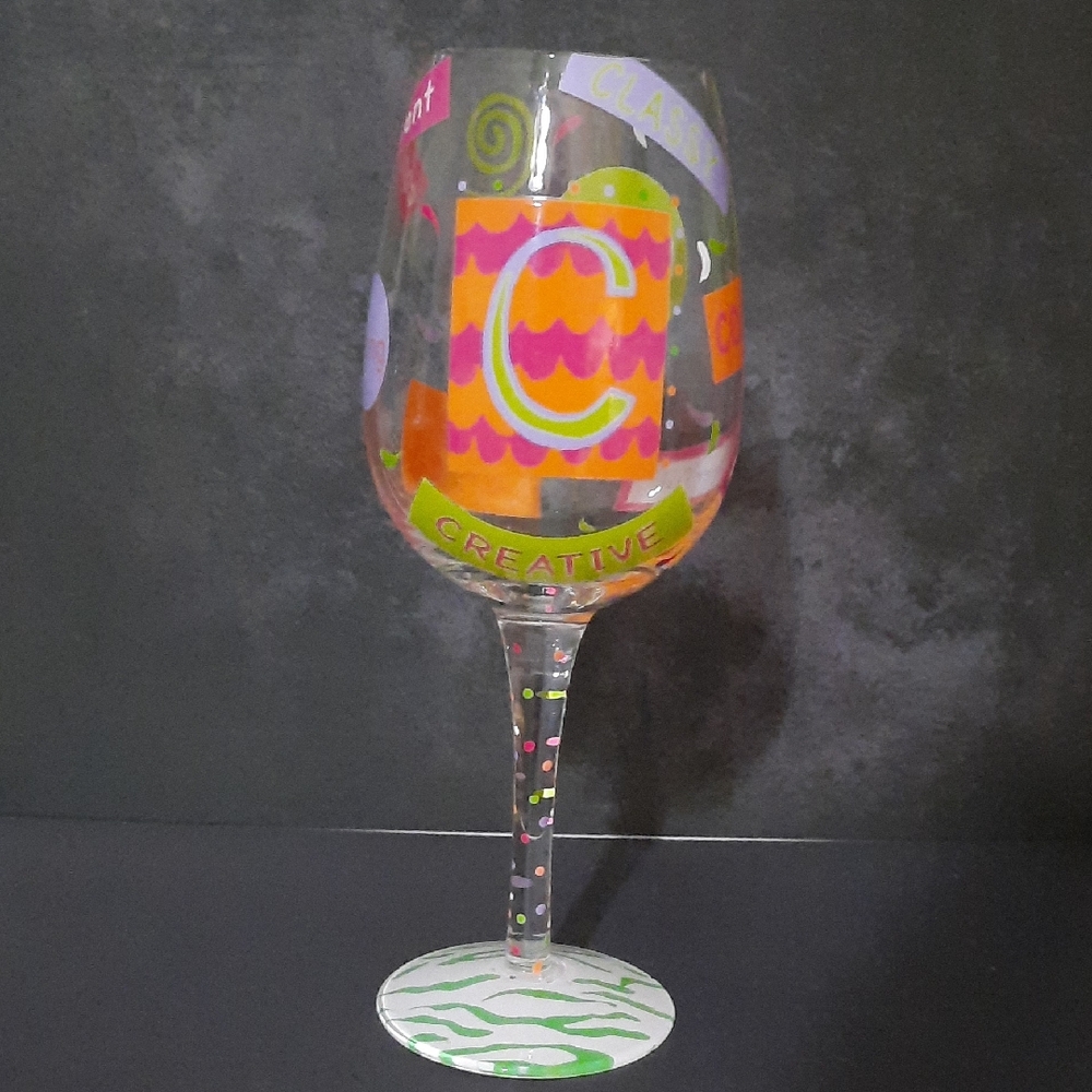 Lolita  Letter "C" Wine Glass with Pink, Orange, and Green Designs.